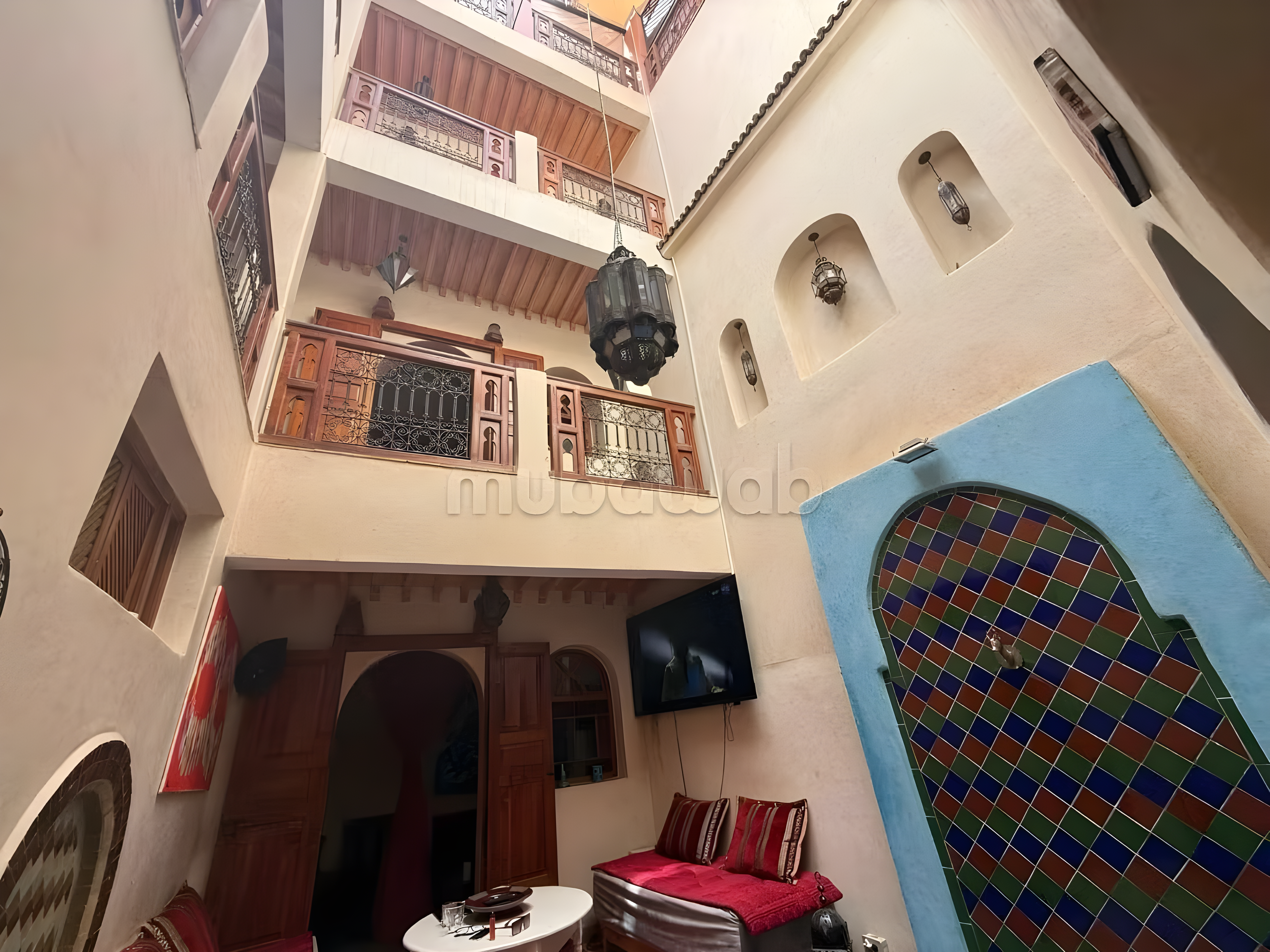 Moroccan guesthouse courtyard in Zaouiat Lahdar with seating and decor