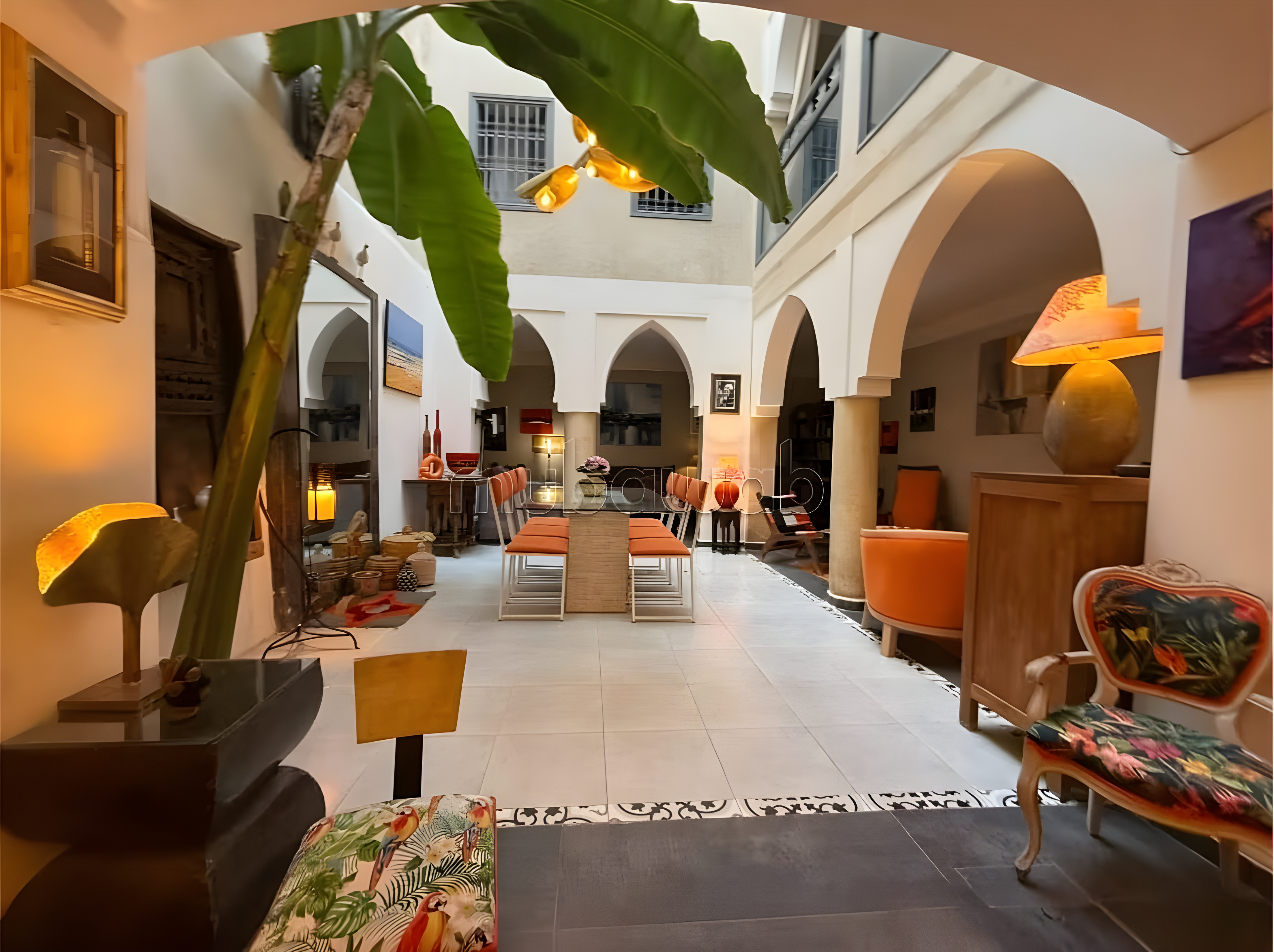 Central courtyard of a Kennaria guesthouse with arches and seating.