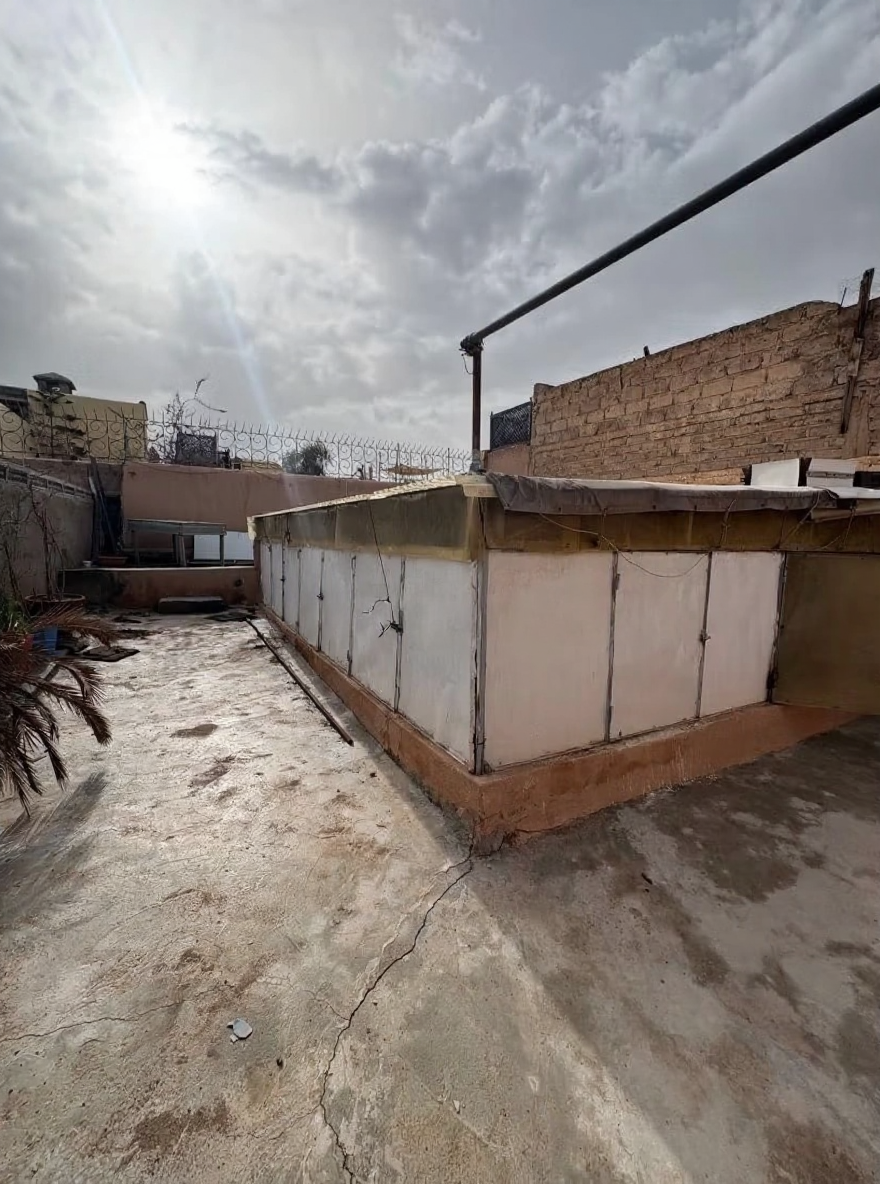 Utilitarian rooftop area of a guesthouse in Sidi Ben Slimane El Jazouli, Marrakech.