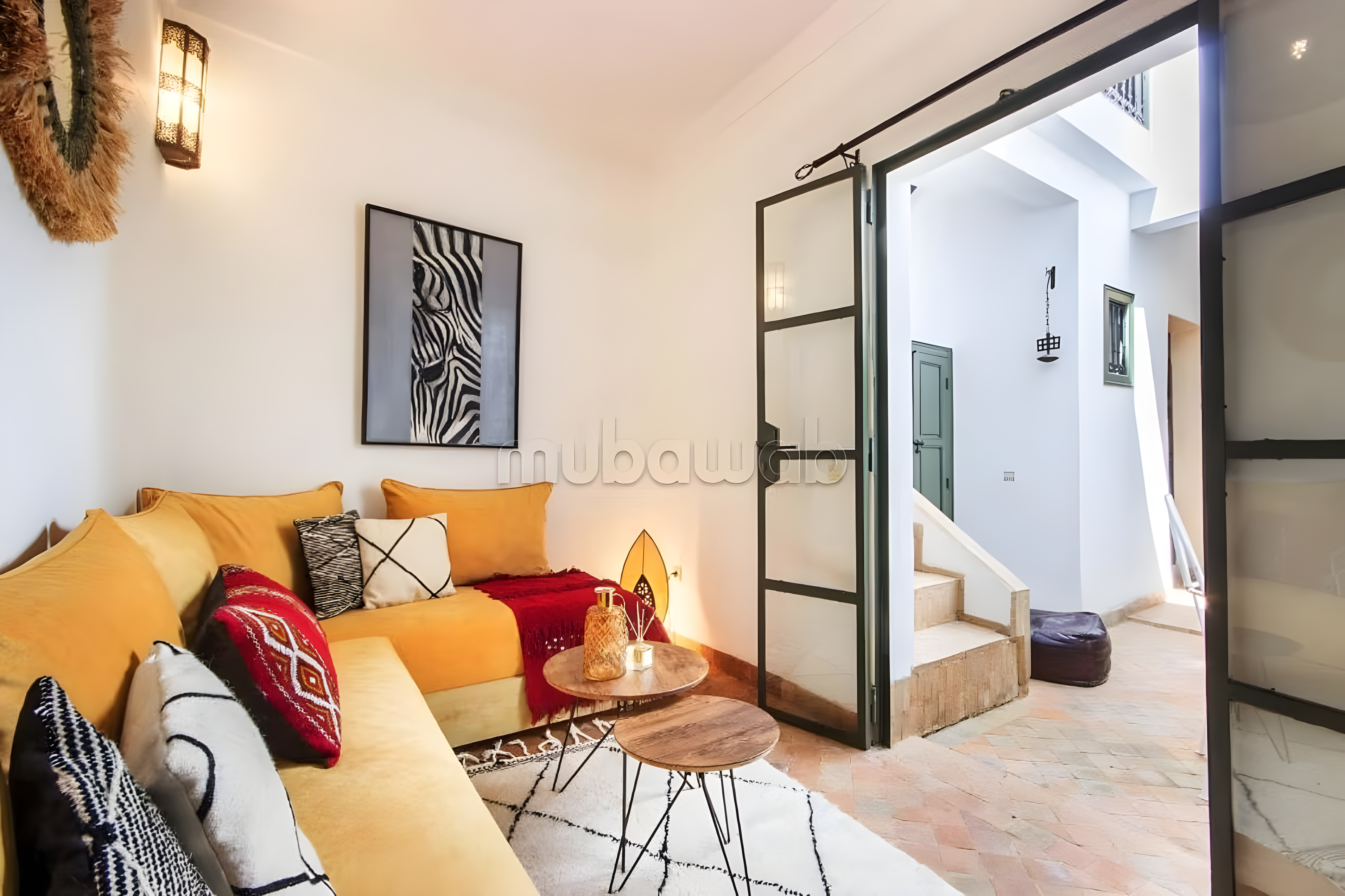 Bright salon with modern seating and Moroccan decor in a Ben Saleh guesthouse.
