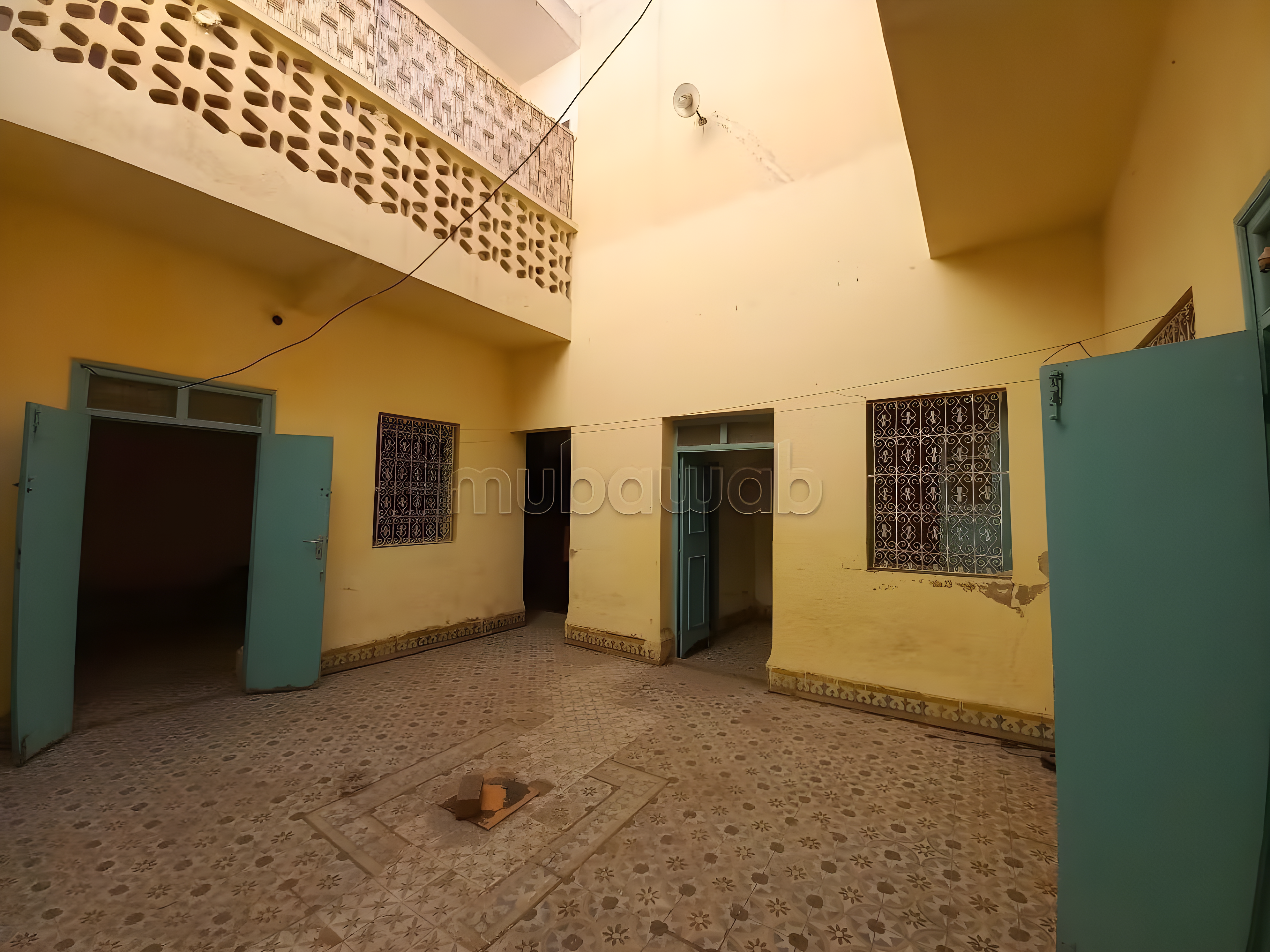 Courtyard of a private residence in Michouar with patterned tiles.