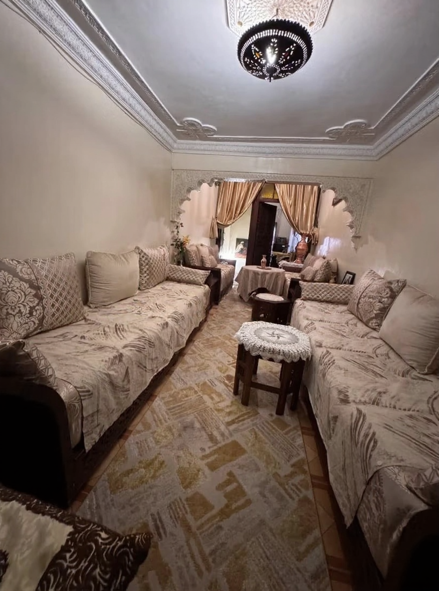 Rmila riad salon with ornate archways and intricate ceilings.