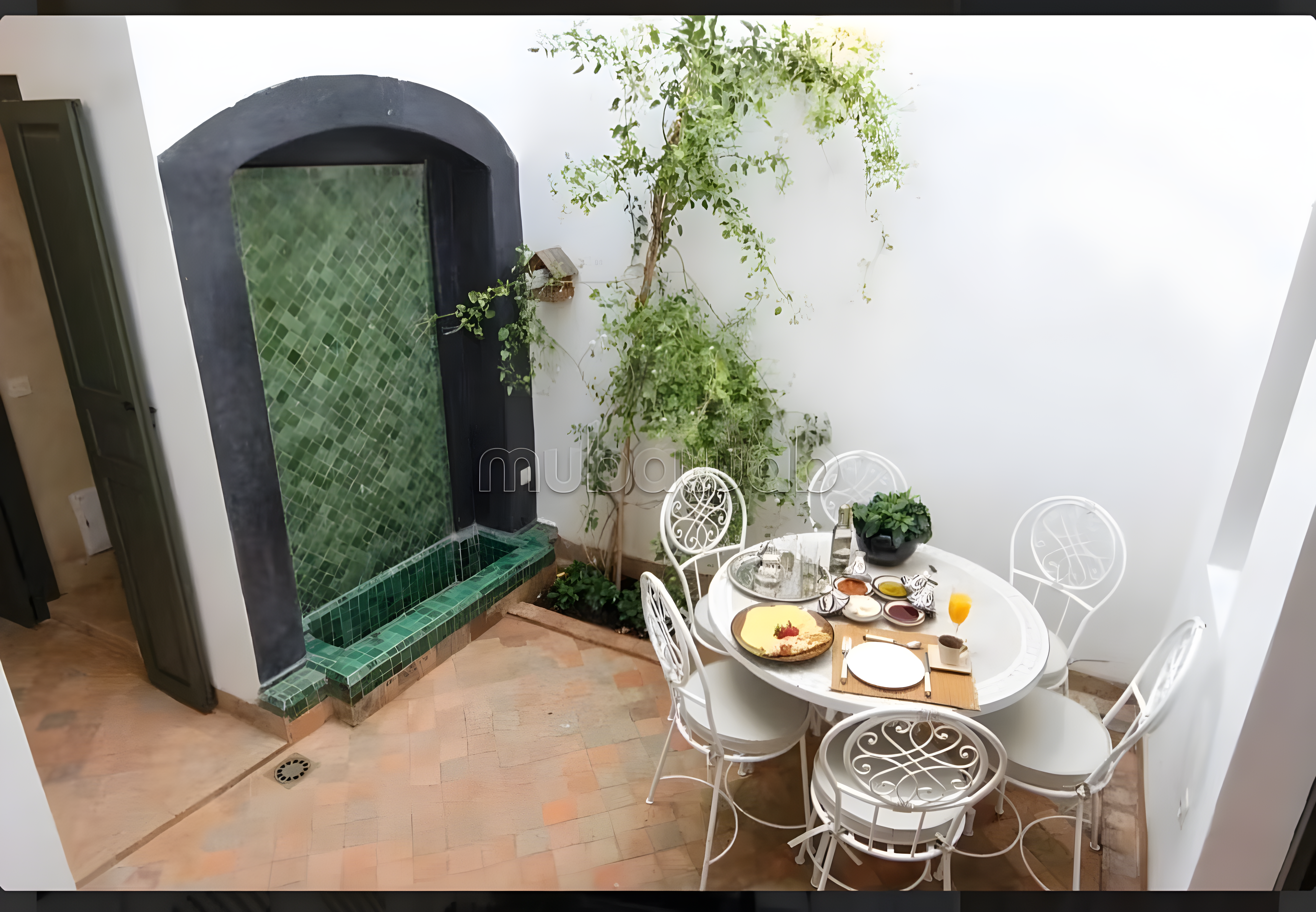 Moroccan courtyard with fountain and dining area in Rahba Kedima.