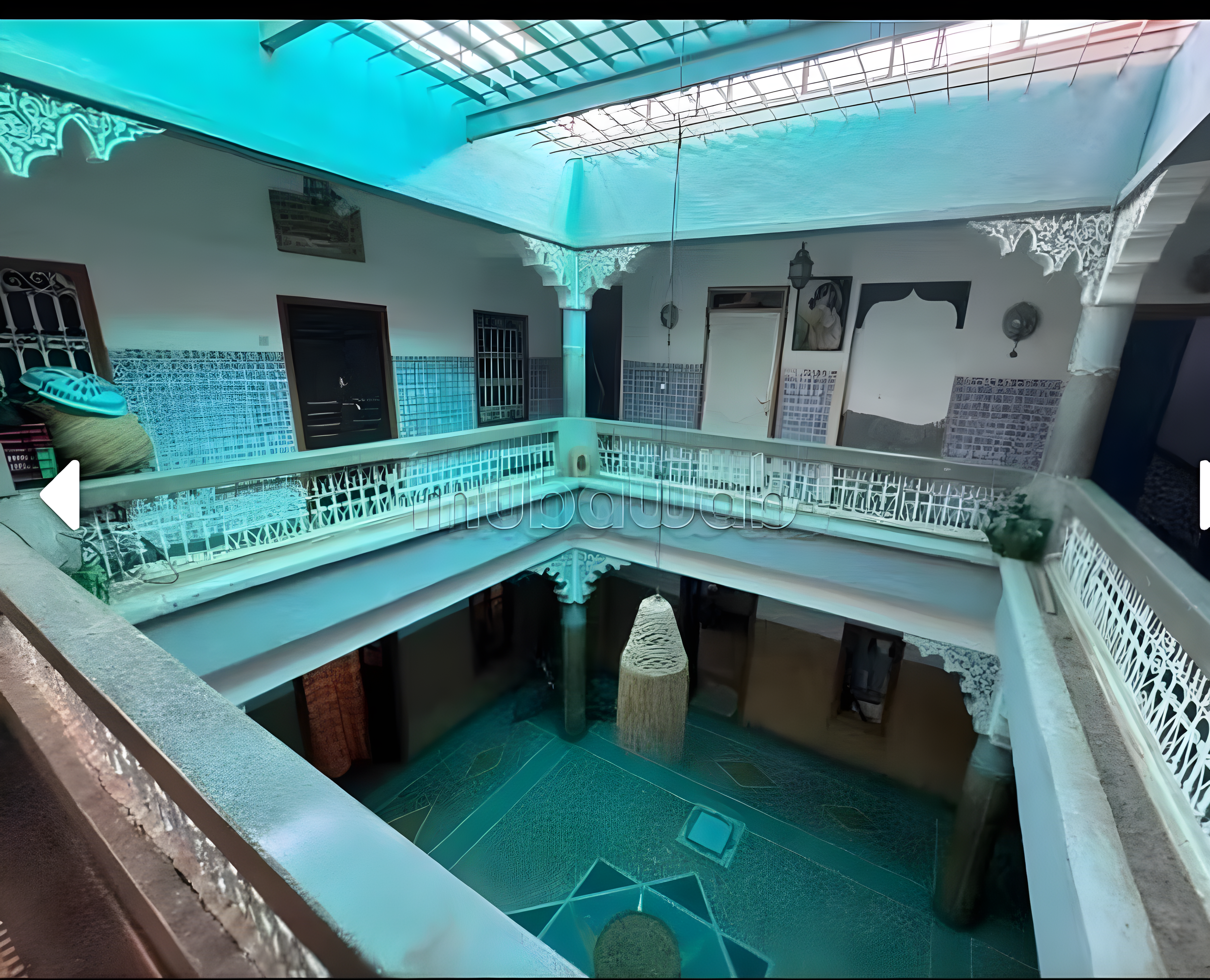 Multi-level courtyard in Arset Ben Chebli with tile flooring and skylight.