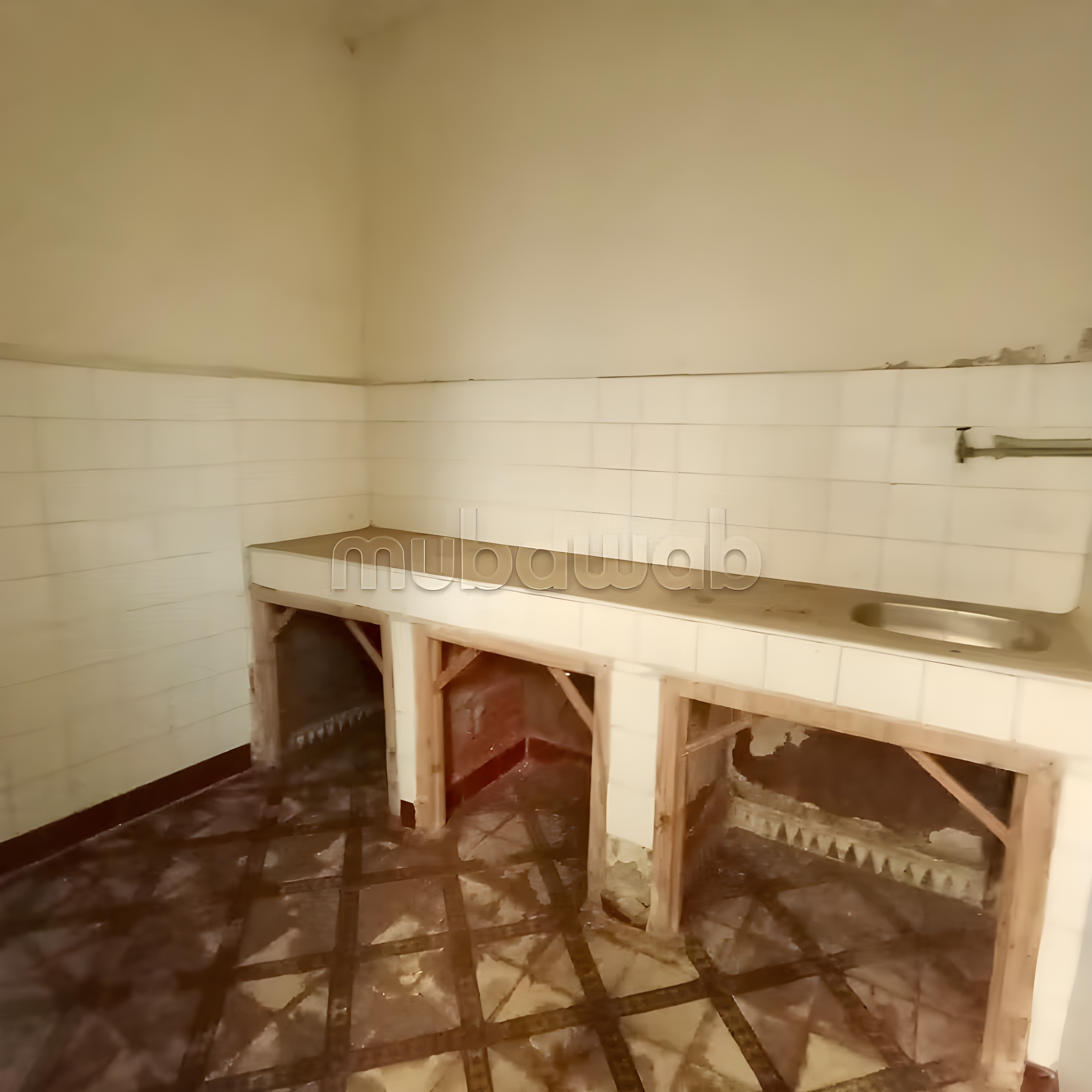 Simple kitchen with tiled walls in Sidi Mansour guesthouse.