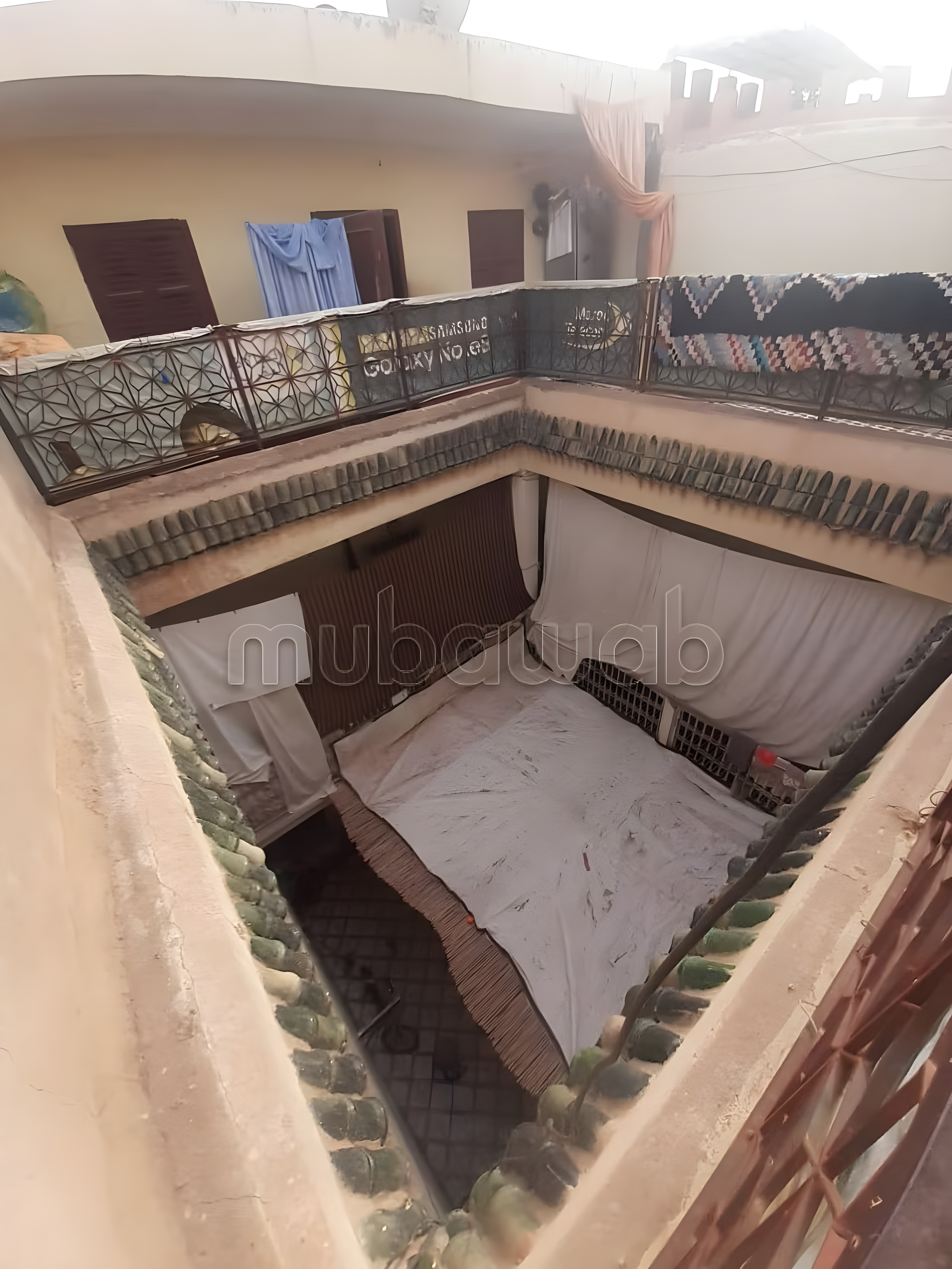 Open courtyard with tiled floor and fabric coverings in Arset Ben Chebli.