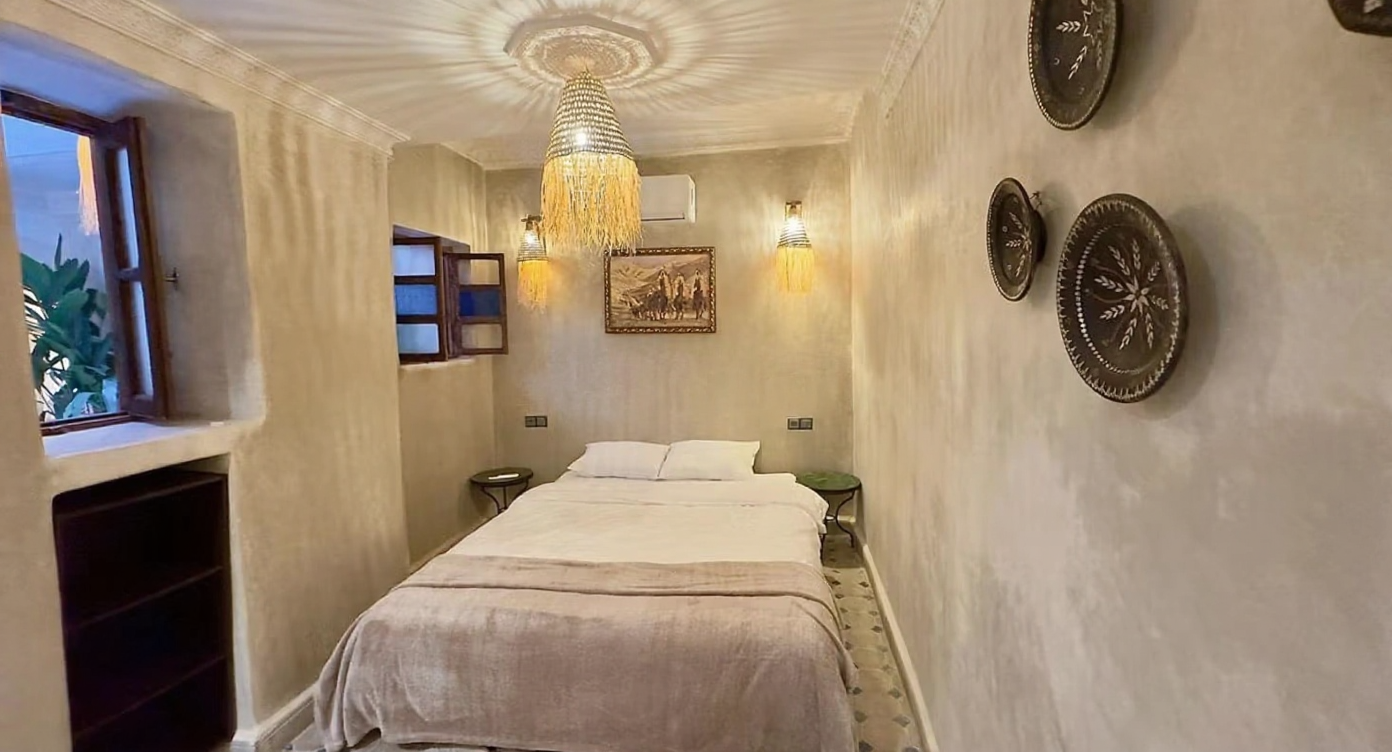 Neutral-toned bedroom with Moroccan decor in Ben Saleh Riad.