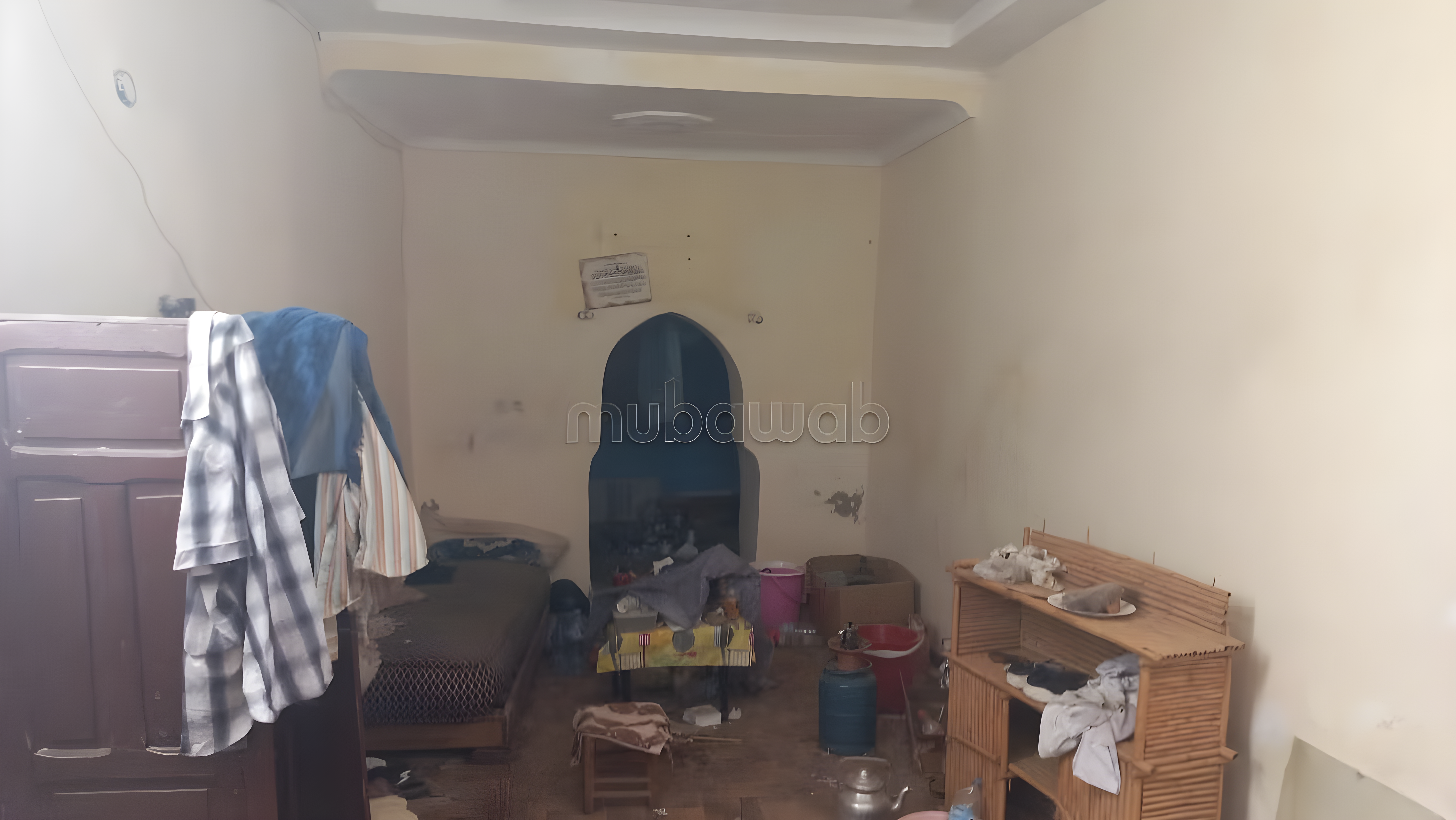 Guesthouse bedroom with simple furniture in Arset El Houta, Marrakesh.