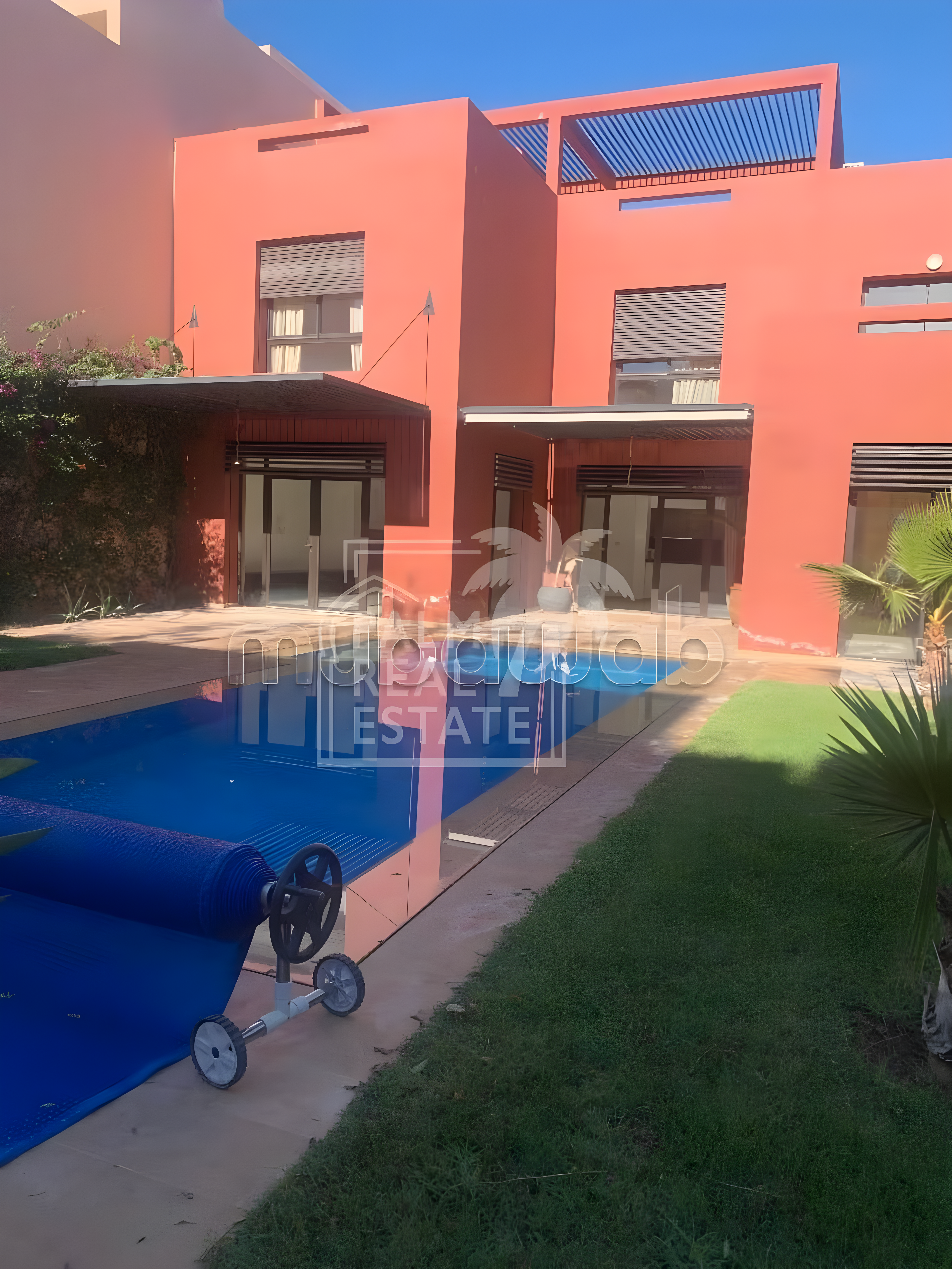 Amelkis guesthouse courtyard with pool and red walls.