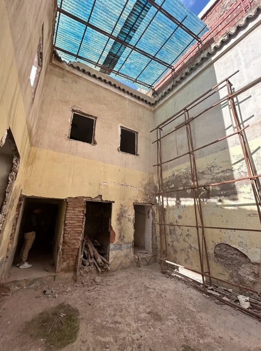 Courtyard of a partially constructed riad in Rahba Kedima under a translucent roof.