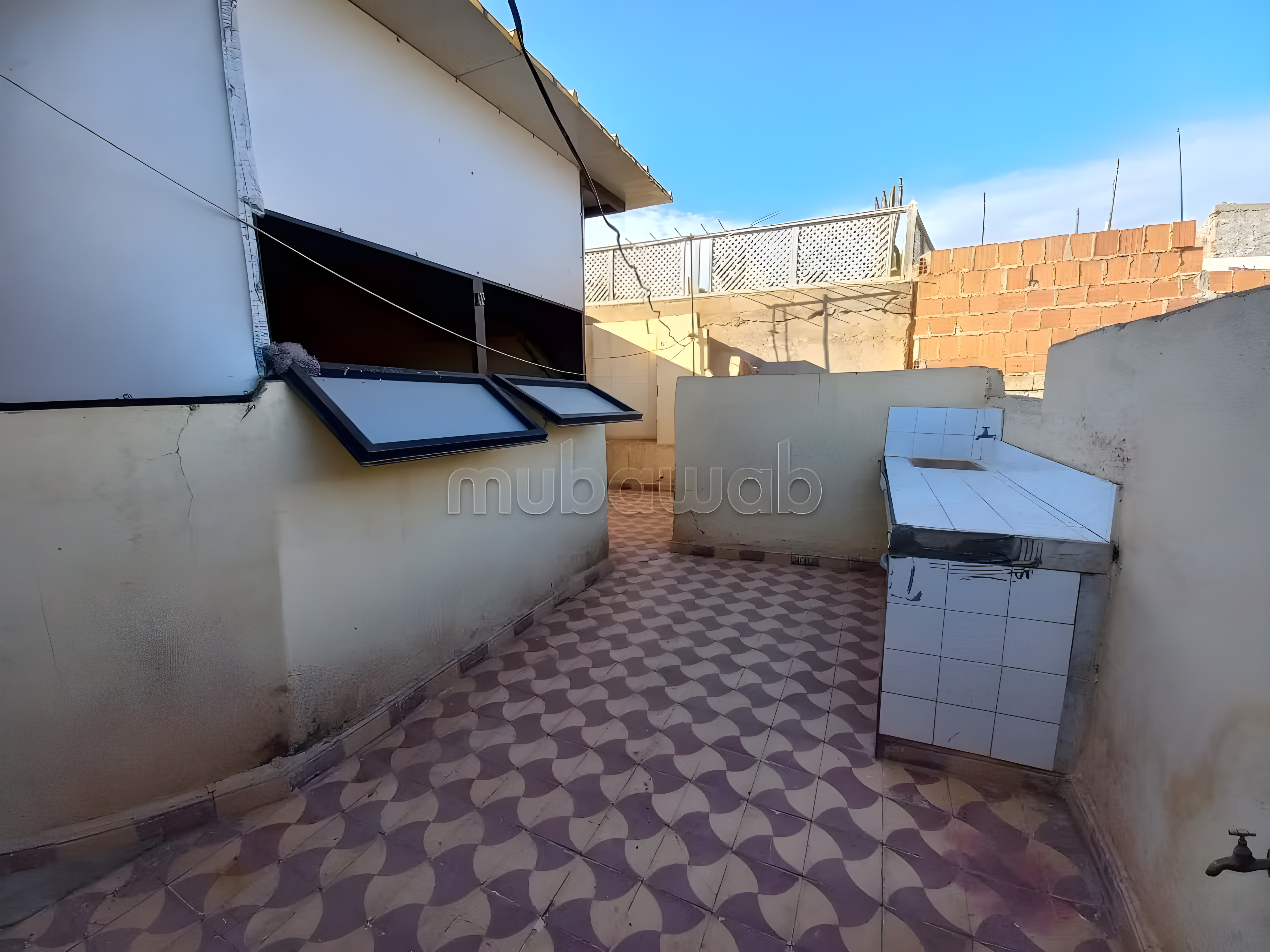 Rooftop in Sidi Mansour with tiled flooring, outdoor sink, and counter.