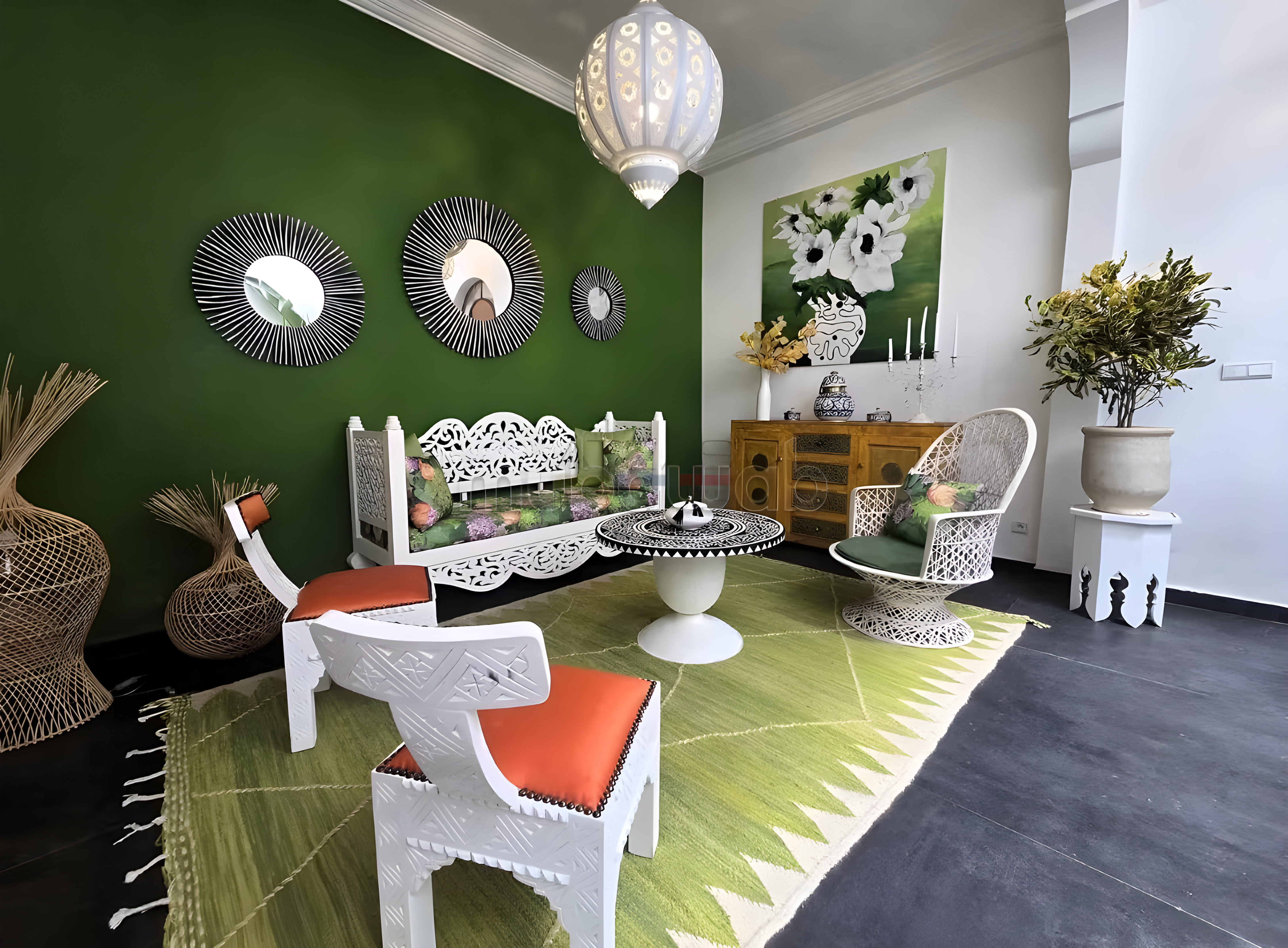 Moroccan-style salon with green wall, ornate furniture, and traditional decor in Moulay Lyazid guesthouse.